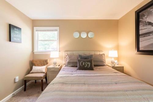 a bedroom with a large bed and a chair at The Beautiful & Cozy Malvec Chalet in Tobyhanna