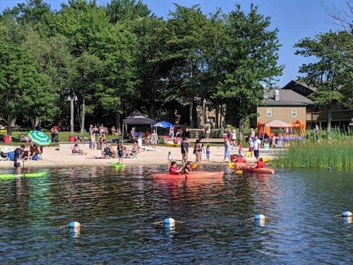 a group of people swimming in a body of water at The Beautiful & Cozy Malvec Chalet in Tobyhanna