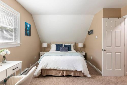 a bedroom with a bed and a white door at The Beautiful & Cozy Malvec Chalet in Tobyhanna