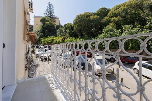 a balcony with an iron railing with a parking lot at Celestial Suites-TOP LOCATION in Corfu Town