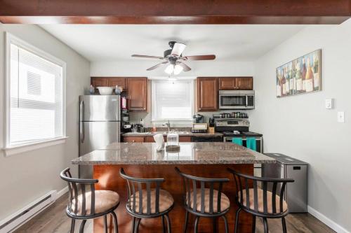 a kitchen with a large island with bar stools at The Beautiful & Cozy Malvec Chalet in Tobyhanna