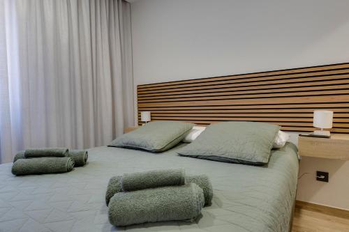 a bedroom with a large bed with two ottomans at Refúgio do Cabo in Sagres