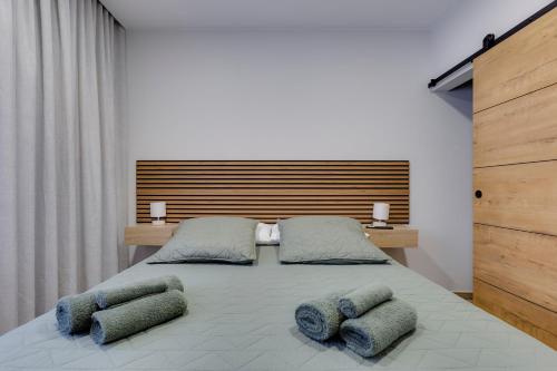a bedroom with a large bed with two pillows at Refúgio do Cabo in Sagres