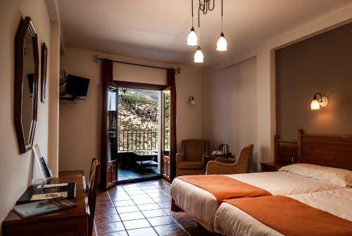 Postel nebo postele na pokoji v ubytování Hotel La Fragua II