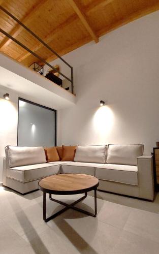 a living room with a couch and a coffee table at Eros and Psyche Suites in Nydri