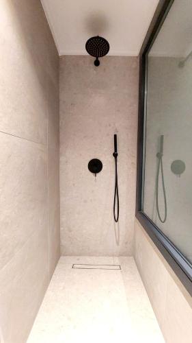 a bathroom with a shower with a shower head at Eros and Psyche Suites in Nydri