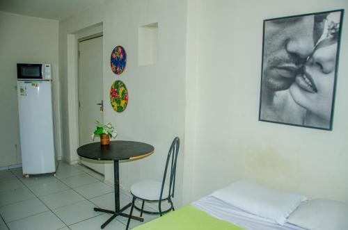 a room with a table and a table and a chair at Studio 51 residence in Recife