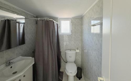 a bathroom with a toilet and a sink at Mytilini House in Carpe Diem Villas & Houses in Kerámion