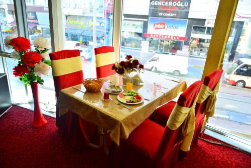a table with a plate of food on it in a restaurant at Kivrak Hotel in Antalya