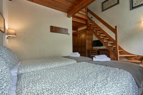a bedroom with a bed and a stair case at Hotel Walser Courmayeur in Courmayeur