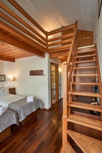 a bedroom with a bunk bed and a staircase at Hotel Walser Courmayeur in Courmayeur