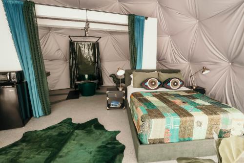 a bedroom with a bed in a tent at DayDreamer Domes in South Haven