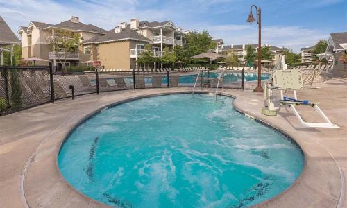 a large swimming pool in a yard with houses at Worldmark Windsor 1BD in Windsor