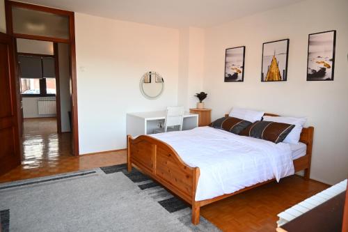 a bedroom with a bed and a mirror on the wall at Golden Valley in Sarajevo