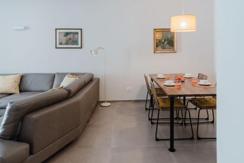 a living room with a couch and a table at Senape - Menaggio by LoveComo in Menaggio
