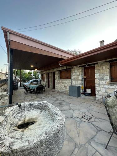 a large stone bowl sitting on a patio at Koilani Vacation House in Koilani