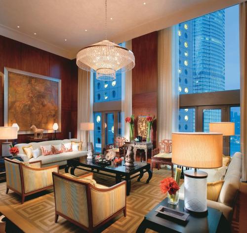 a living room filled with furniture and a chandelier at Mandarin Oriental, Hong Kong in Hong Kong