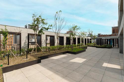 an exterior view of a building with a courtyard at OOD Hotel Taipei HangZhou in Taipei