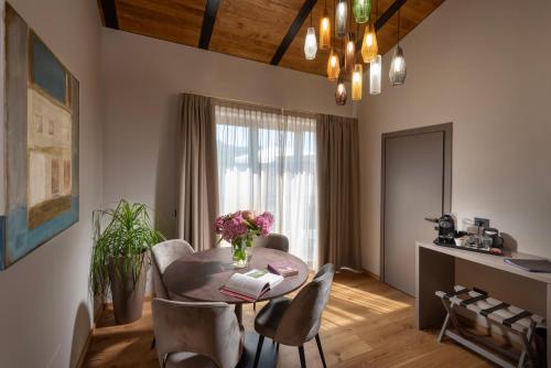 a living room with a table and chairs and a dining room at Relais PQlin in Castagnito