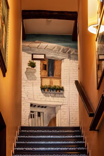 a painting of a staircase in a building at Hotel La Fragua II in Trevélez