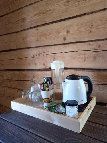 a tray with a tea kettle and cups on it at Vastseliina Metskond Camping in Vahtseliina