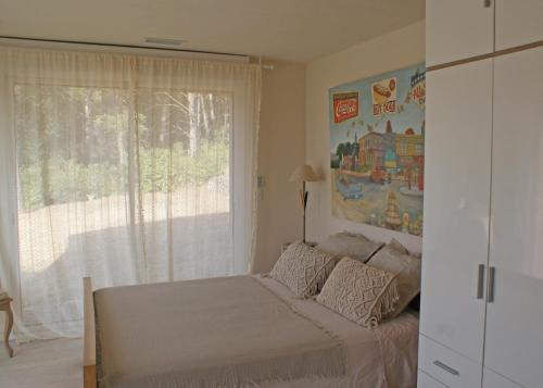 a bedroom with a bed in front of a window at L'Irisciabella in Lourmarin