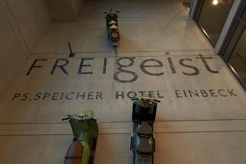 a sign on a wall with two motorcycles on it at Hotel FREIgeist Einbeck BW Signature Collection in Einbeck