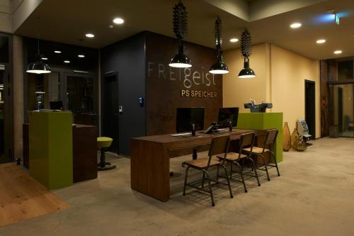 a room with a desk with a laptop on it at Hotel FREIgeist Einbeck BW Signature Collection in Einbeck