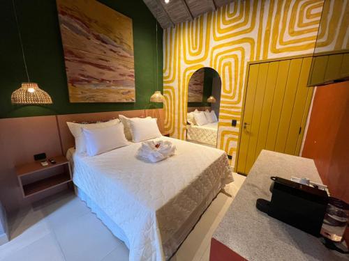 a bedroom with a bed with a stuffed animal on it at Pousada Refúgio de Maresias in Maresias
