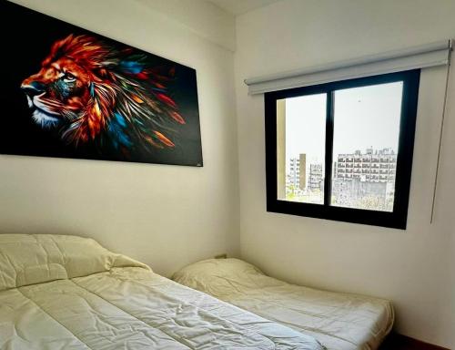 a bedroom with a painting of a lion on the wall at Center Suites, 3 ambientes con cochera opcional in La Plata