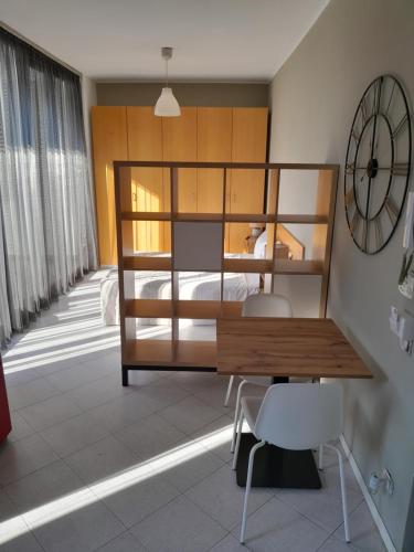 a bedroom with a bed and a desk and a clock at Gerenzano Apartments in Gerenzano
