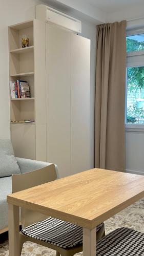 a wooden table in a living room with a couch at Omis apartment - near beach and town center, ground floor with small garden in Omiš