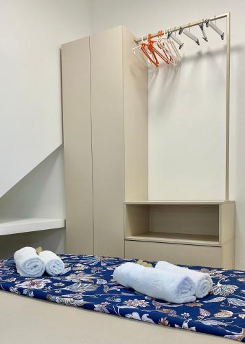 a room with a bed with towels on it at Omis apartment - near beach and town center, ground floor with small garden in Omiš