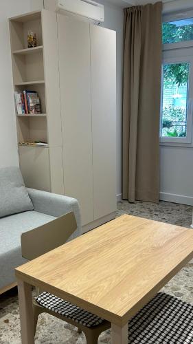 a living room with a wooden table and a couch at Omis apartment - near beach and town center, ground floor with small garden in Omiš