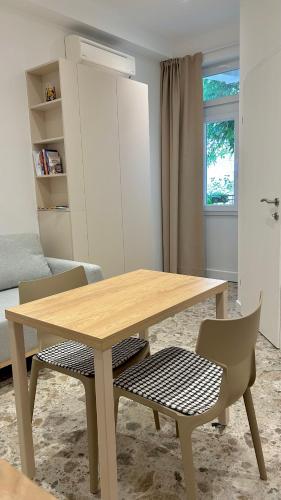 a wooden table and two chairs in a room at Omis apartment - near beach and town center, ground floor with small garden in Omiš