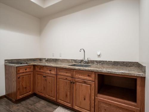 une cuisine avec un évier et des armoires en bois dans l'établissement Grand View - Targhee Ski Resort, Jackson, Hot Tub, à Tetonia