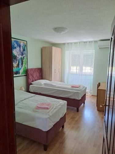 a bedroom with two beds and a window at Vila Jasmina in Bihać