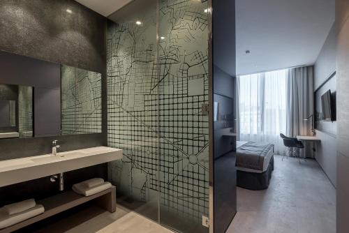 a bathroom with a shower and a sink and a mirror at Negresco Princess 4* Sup in Barcelona
