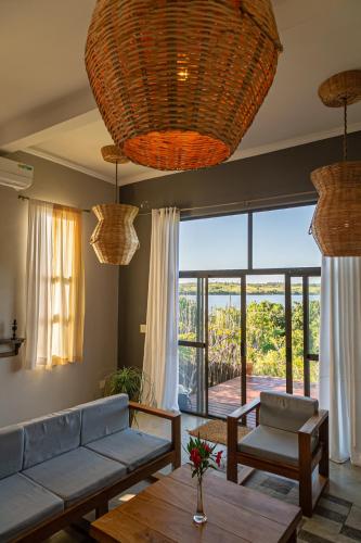 a living room with a couch and a table at Naara Eco Lodge & Spa in Chidenguele