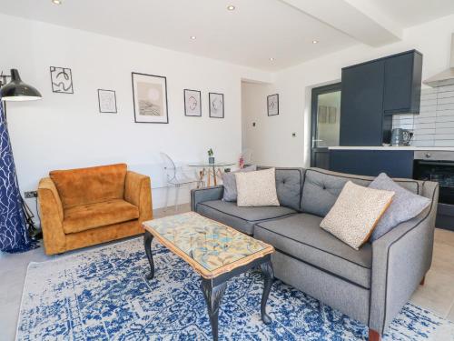 a living room with a couch and a coffee table at Priestleys Retreat in Blackburn