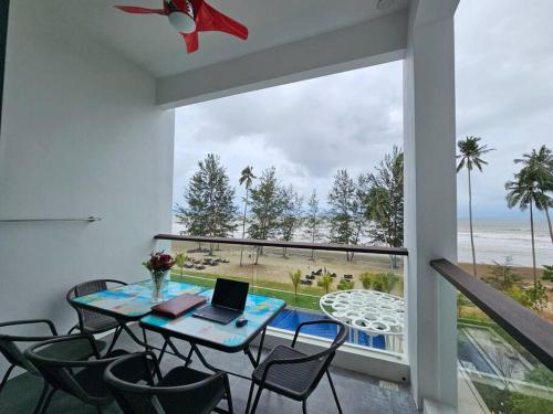 a room with a table and chairs with a laptop on it at Kenyalang Roxy Sematan Homestay in Sematan