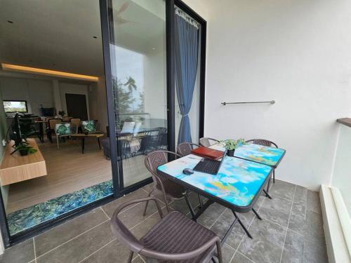 a room with a table with a laptop on it at Kenyalang Roxy Sematan Homestay in Sematan