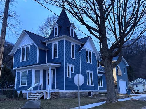 a blue house with a stop sign in front of it at The Glarum House - Gorgeous Historic Home & Ac! in Elberta