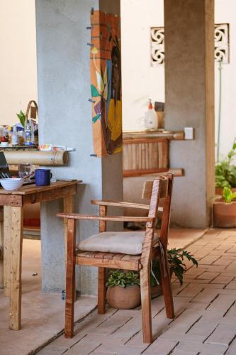 a wooden chair sitting in front of a table at Bambú Corner - Casa Consciente in Brisas de Zicatela