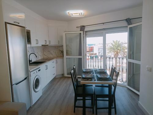 a kitchen with a table and chairs and a kitchen with a window at CASA ALAIA in Arguineguín