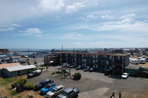 a parking lot with cars parked in front of a building at Westport Inn in Westport