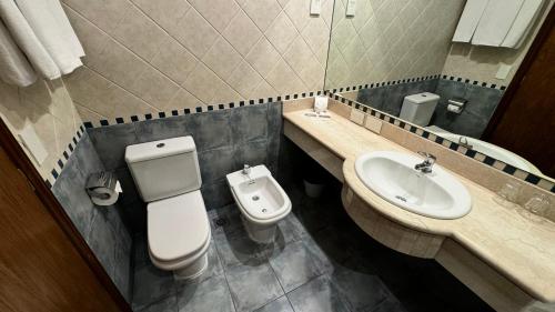 a bathroom with a toilet and a sink at Gardi Hotel & Suites in Buenos Aires