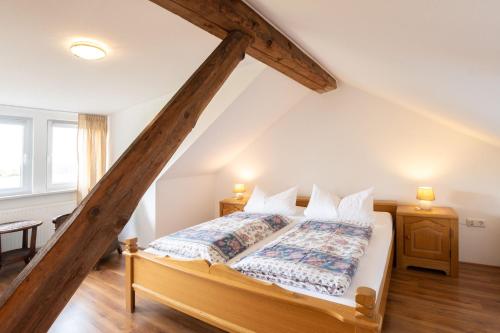 a bedroom with a bed in a attic at Ferienwohnung Birken Allee, 35181 in Schwerinsdorf