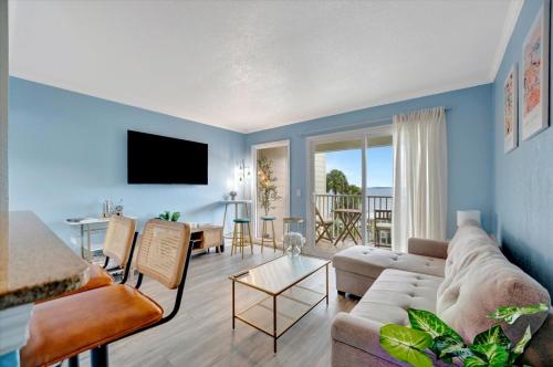 a living room with a couch and a table at Serenity on the Sea Luxury Condo with Private Balcony on the Ocean in Tampa