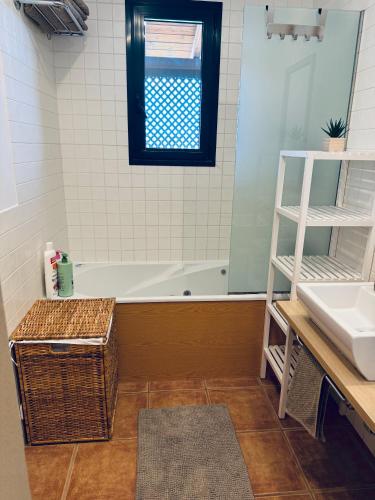 a bathroom with a bath tub and a sink at Take It EaSea in San Miguel de Abona